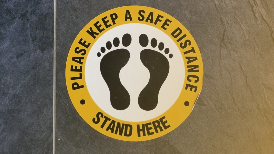 Floor signage can help keep a safe social distance throughout your business